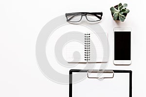 Modern flat lay with office items on white desk background top view mockup