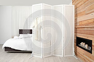 Modern folding screen in stylish bedroom