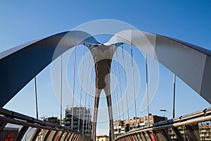 Modern footbridge with supporting arches and steel bulkheads photo