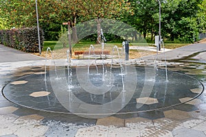 Modern fountain with jets of water gushing out of ground