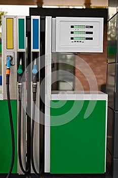 Modern fuel dispenser at gas station in daytime
