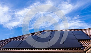 Modern full black solar panels on the roof of a private house