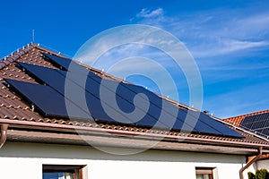 Modern full black solar panels on the roof of a private house