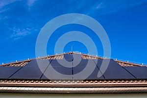 Modern full black solar panels on the roof of a private house