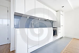 Modern fully fitted kitchen in white and gray