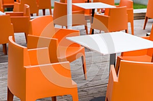 Modern furniture outdoor cafe terrace with orange chairs