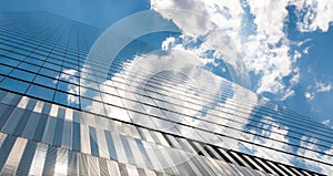 Modern futuristic glass facade of corporate finance office skyscraper business building architecture blue sky glass reflection.