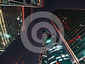 Modern futuristic skyscrapers buildings in business center in Moscow city at night with illuminated windows and lights