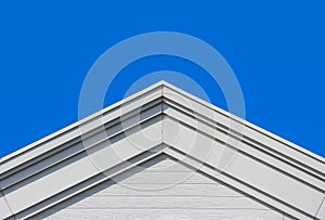 modern gable roof design house facade wall with clear blue sky background.