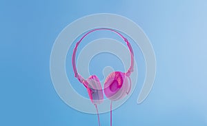 Modern gadget for music. Big white headphones on blue background in neon