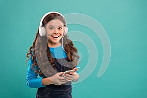 Modern gadgets. Girl listen music modern headphones and smartphone. Listen for free. Music subscription. Enjoy music