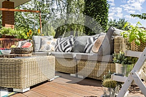 Modern garden patio with rattan sofa photo