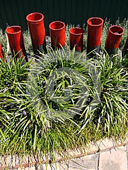 Modern garden: red ceramic sculptures grass border