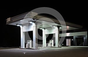 Modern gas station with convenience store beside the road at night