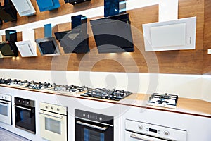 Modern gas stoves and hoods on display in store