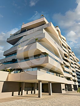 Modern Geometric Apartment Building with Large Balconies Under Blue Sky photo