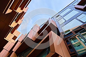 Modern geometric building facade with angular metal panels and glass windows