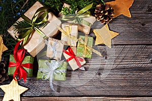 Modern gifts on a wooden rustic table with copy space. Christmas background. View from above.