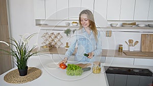 Modern girl chooses from which vegetable to prepare salad and sm