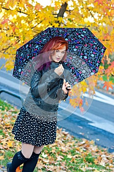 Modern girl with umbrella in autumn