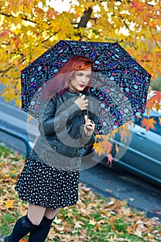 Modern girl with umbrella in autumn