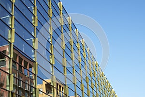 Modern glass building with reflections of other buildings.