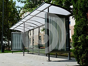 Modern glass bus shelter with polka dots on aluminum frame