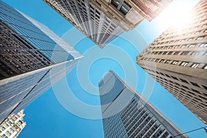 Modern glass and classic tall office buildings in New York. A perspective view from below