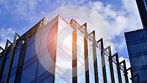 Modern glass facade against blue sky.