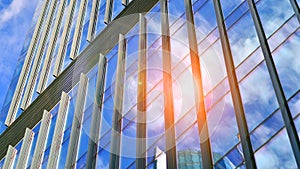 Modern glass facade against blue sky.