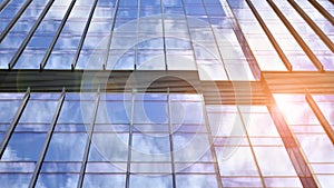 Modern glass facade against blue sky.