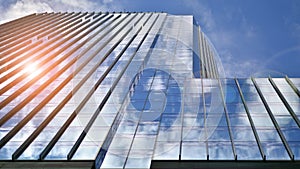 Modern glass facade against blue sky.