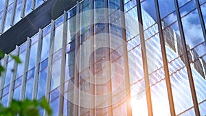 Modern glass facade against blue sky.