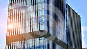 Modern glass facade against blue sky.