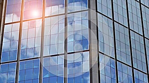 Modern glass facade against blue sky.