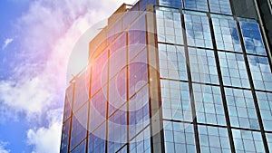 Modern glass facade against blue sky.