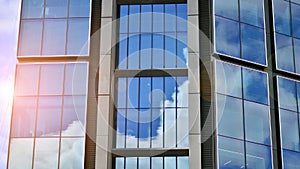 Modern glass facade against blue sky.