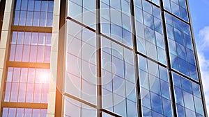 Modern glass facade against blue sky.