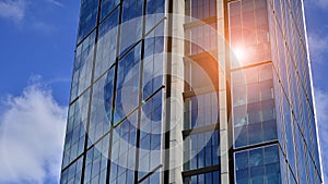 Modern glass facade against blue sky.