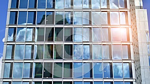 Modern glass facade against blue sky.