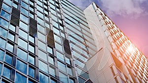 Modern glass facade against blue sky.