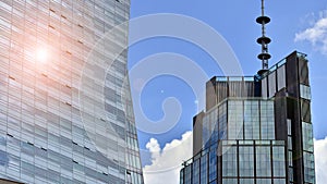 Modern glass facade against blue sky.