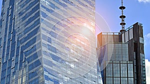 Modern glass facade against blue sky.