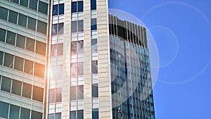 Modern glass facade against blue sky.