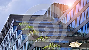 Modern glass facade against blue sky.