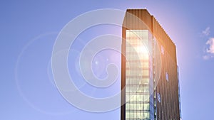 Modern glass facade against blue sky.