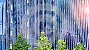 Modern glass facade against blue sky.