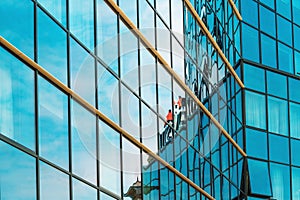 Modern glass facade of corporate business office building in financial downtown district as abstract geometrical and architectural