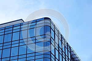 modern glass facade office building against blue sky