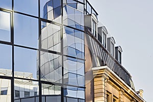 Modern glass facade beside old building in Lille, France